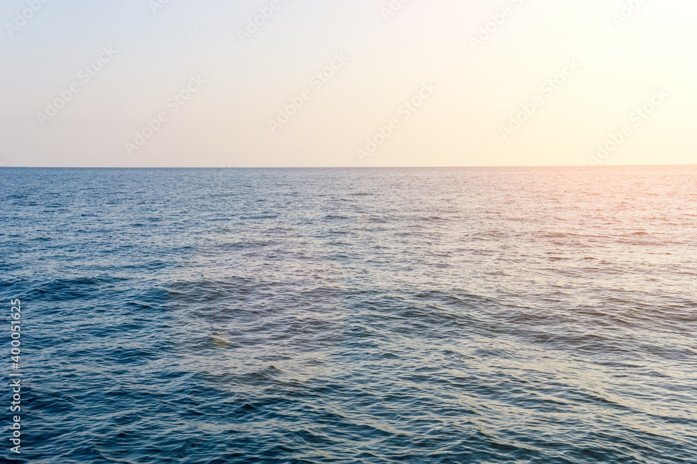 Obraz premium Panoramic sunset view over the sea. Nothing but sky and water. space for text