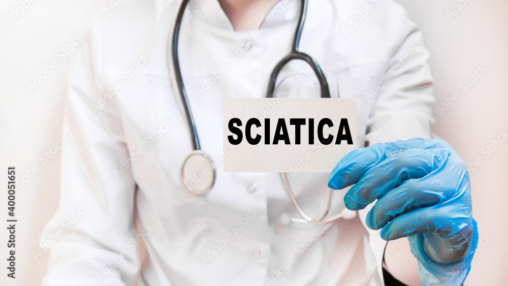 The doctor's blue - gloved hands show the word SCIATICA - . a gloved hand on a white background. Medical concept. the medicine The doctor's blue - gloved hands show the word SCIATICA - . a gloved hand on a white background. Medical concept. the medicine