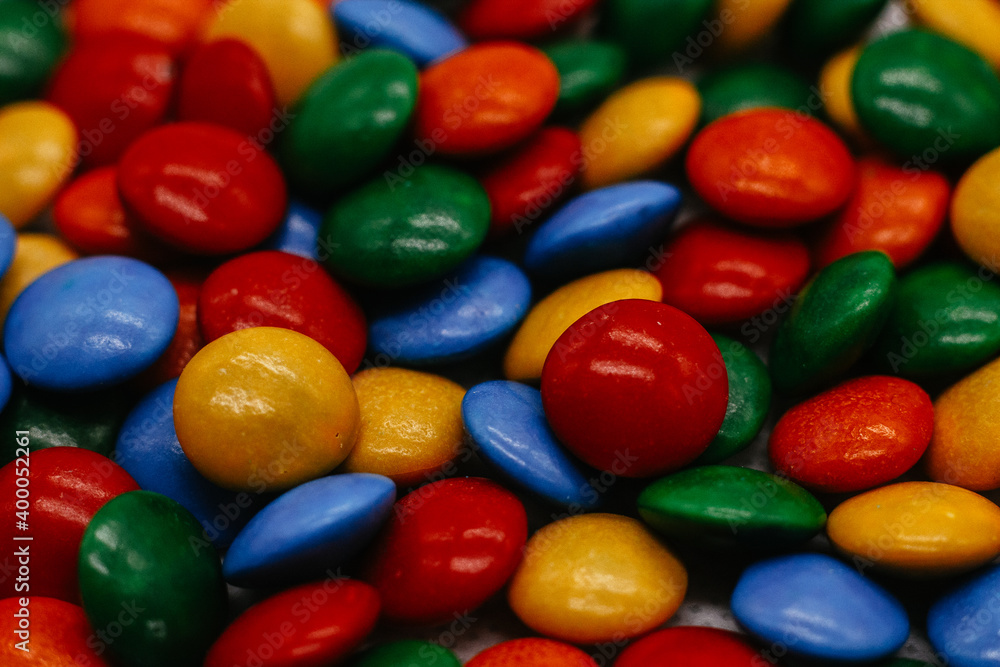 background of small round multicolored sweets close-up