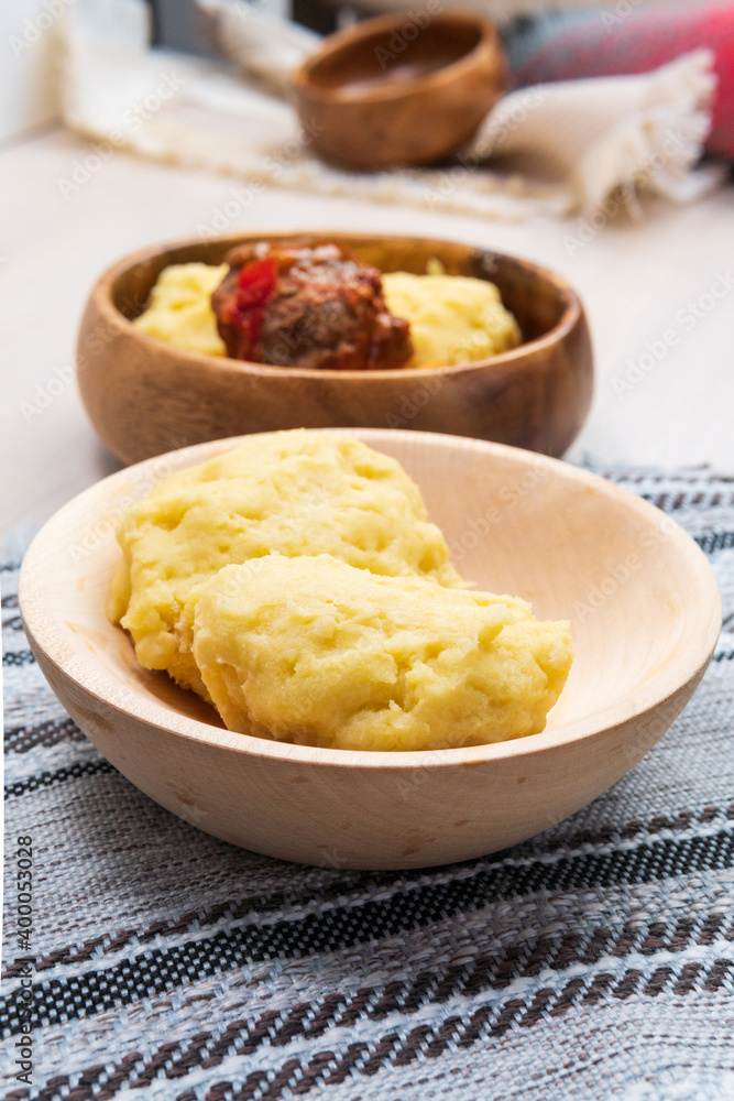 Zambian cuisine is nshima, which is a food prepared from pounded white maize. vertical photo Zambian cuisine is nshima, which is a food prepared from pounded white maize. vertical photo