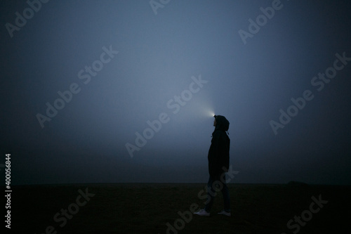 Girl at night in the fog.