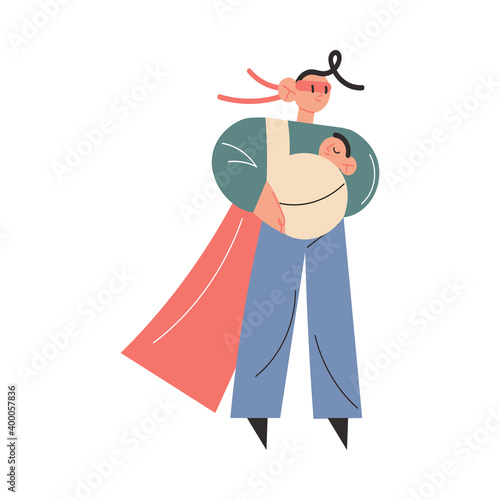 Father in superhero costume and mask carrying small baby in sling