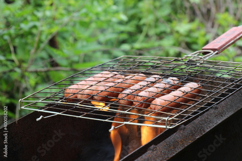 Barbecue with sausages grilling over a fire 