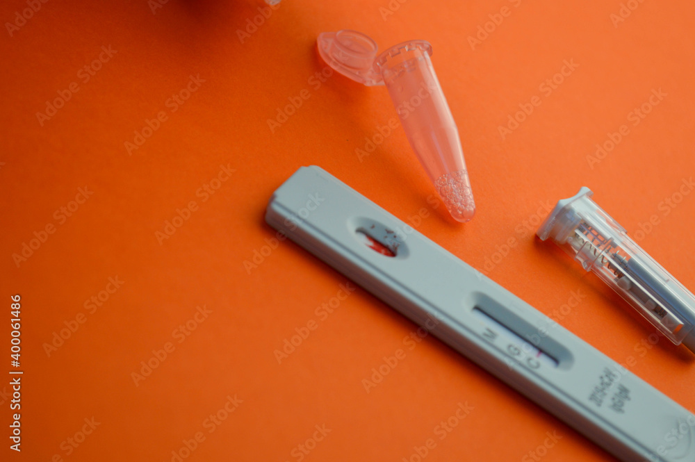 Negative test for antibodies to covid-19 virus. Bright orange table, copy space Negative test for antibodies to covid-19 virus. Bright orange table, copy space