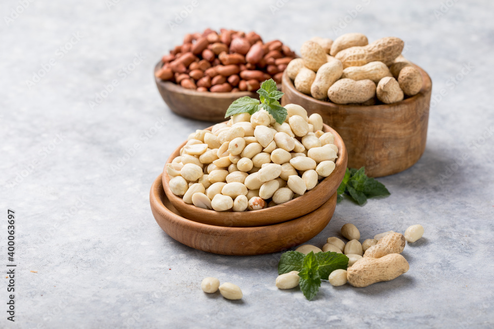 Raw dried fresh peanut nuts on a stone background Raw dried fresh peanut nuts on a stone background