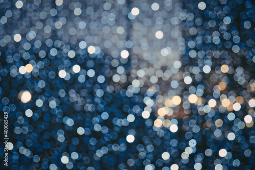 Abstract background with blue blurred lights with bokeh effect. Christmas celebration concept.