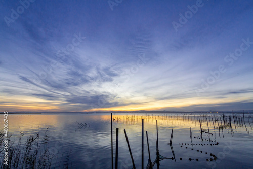 Lake in the blue hour of sunset with blue and gold tones in La Albufera de Valencia (Spain)