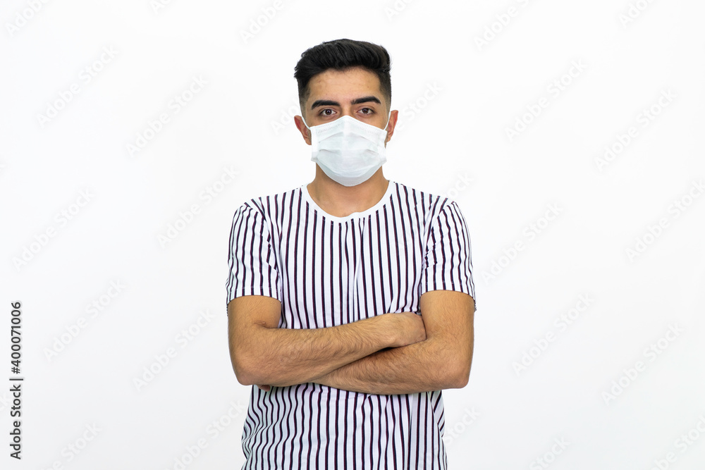 Young male wearing a medical face mask. Isolated image and white background. Young male wearing a medical face mask. Isolated image and white background.