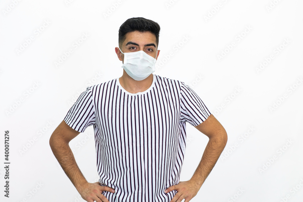 Young male wearing a medical face mask. Isolated image and white background. Young male wearing a medical face mask. Isolated image and white background.