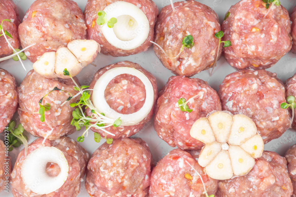 raw meat balls with vegetables and microgreens isolated on white raw meat balls with vegetables and microgreens isolated on white