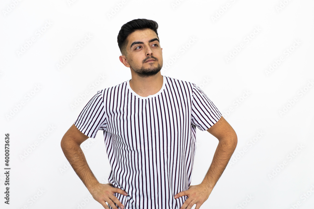 Young man wearing a white striped shirt. He has a short beard. White background. Isolated image. Young man wearing a white striped shirt. He has a short beard. White background. Isolated image.