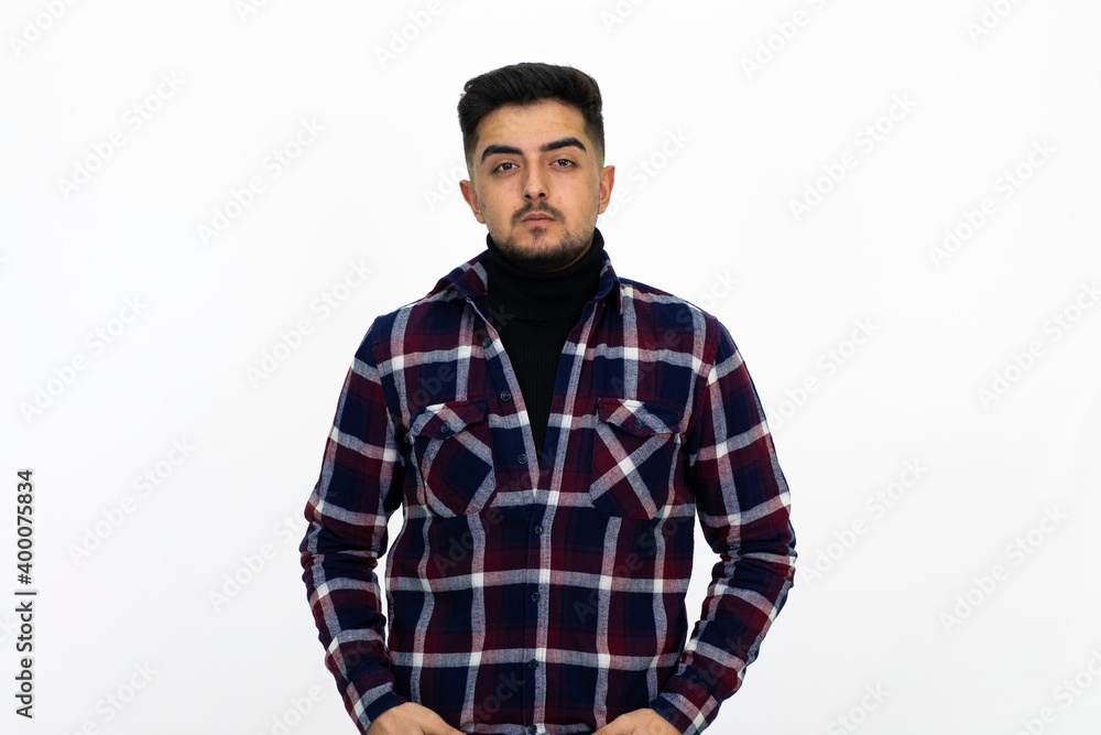 Young man wearing a dark striped shirt. He has a dirty beard White background. Isolated image. Young man wearing a dark striped shirt. He has a dirty beard White background. Isolated image.