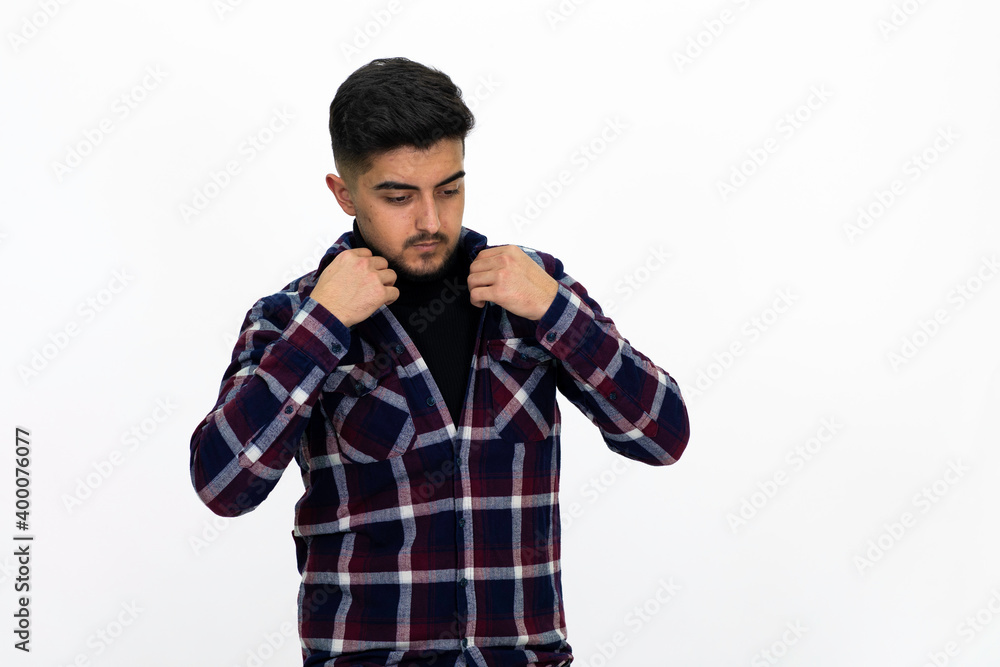 Young man wearing a dark striped shirt. He has a dirty beard White background. Isolated image. Young man wearing a dark striped shirt. He has a dirty beard White background. Isolated image.