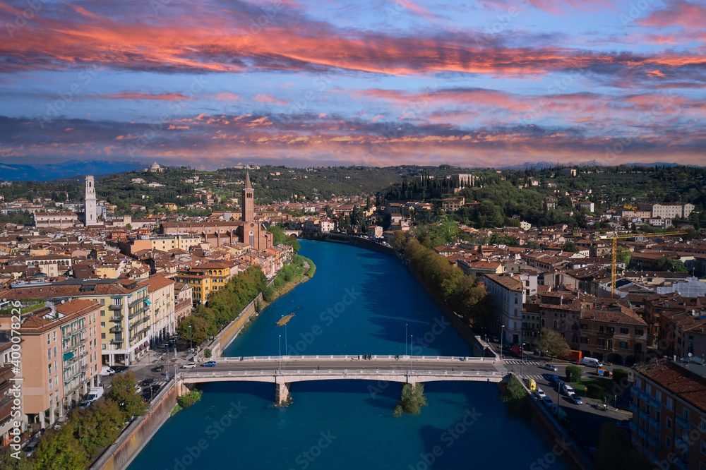 Verona aerial panoramic view. View of the historic city center along Adige river in Verona, Italy. Pink cumulus clouds in the sky. Beautiful panoramic view. Aerial photography with drone.