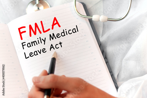 Doctor holding a card with text FMLA Family Medical Leave Act medical concept photo