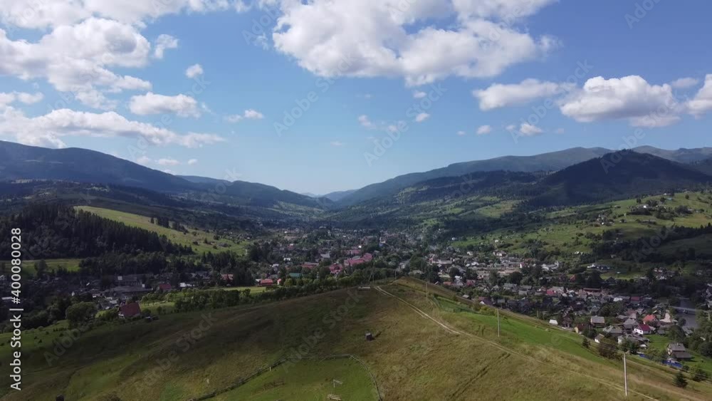 Small mountain village in summer. Green mountains with trees. View of the Carpathian Mountains. Yasinia. Ukraine. Europe Small mountain village in summer. Green mountains with trees. View of the Carpathian Mountains. Yasinia. Ukraine. Europe