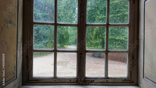 A look at the empty alleys of the park through a closed window
