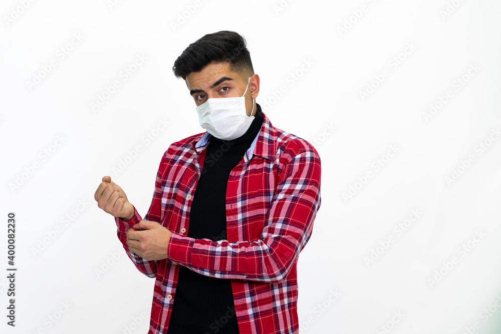 Young man wearing a medical mask. He wears a striped red shirt. Young man wearing a medical mask. He wears a striped red shirt.
