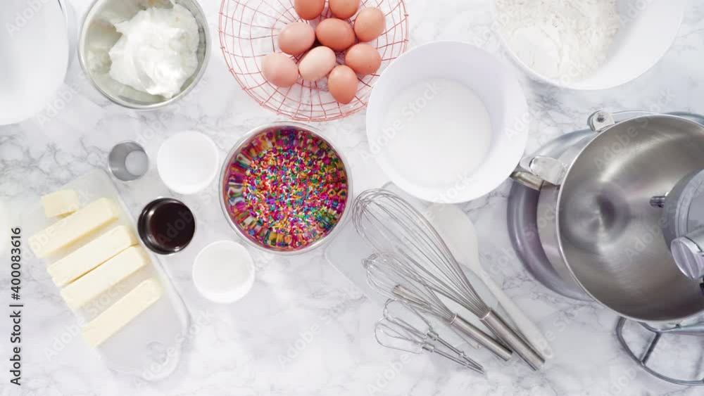 Flat lay. Step by step. Mixing ingredients in standing kitchen mixer to make funfetti cake. Flat lay. Step by step. Mixing ingredients in standing kitchen mixer to make funfetti cake.