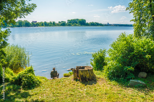 fisherman by the lake in elk, poland
