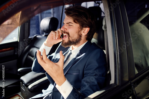 business man in a suit talking on the phone in a car finance model © SHOTPRIME STUDIO