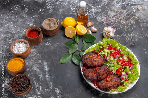 top view tasty meat cutlets with vegetable salad on grey floor photo food meal dish