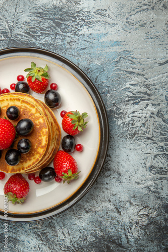 top view delicious pancakes with fruits and berries on a light background dessert fruit cake