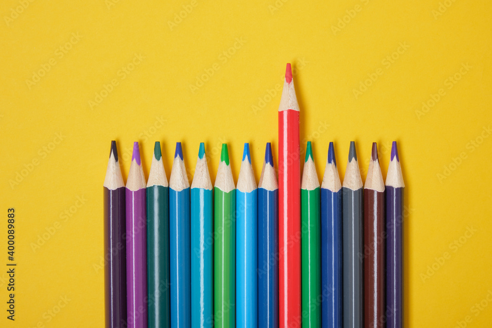 color pencils on yellow background top view color pencils on yellow background top view