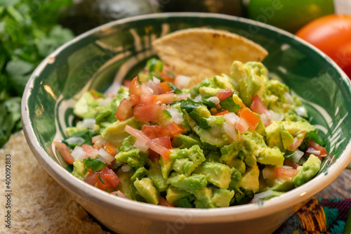 Mexican guacamole on wooden background