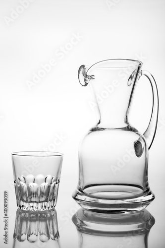 Slim glass water jug and glass. Containers for feeding water in the household.