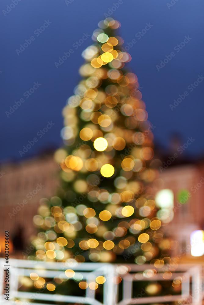 christmas tree on the street out of focus. bokeh festive garlands