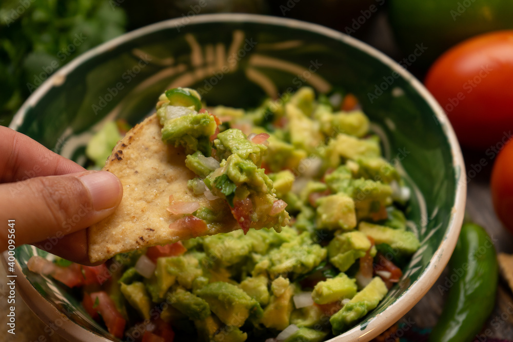 Mexican guacamole on wooden background