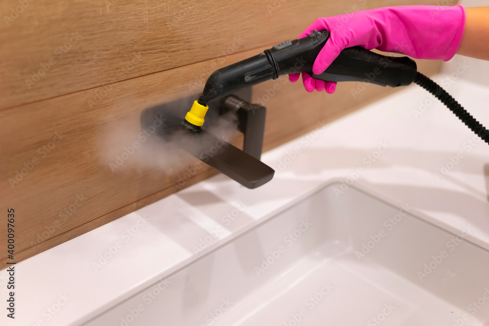 Cleaning the faucet from fungi and dirt with steam cleaner. Bathroom cleaning process