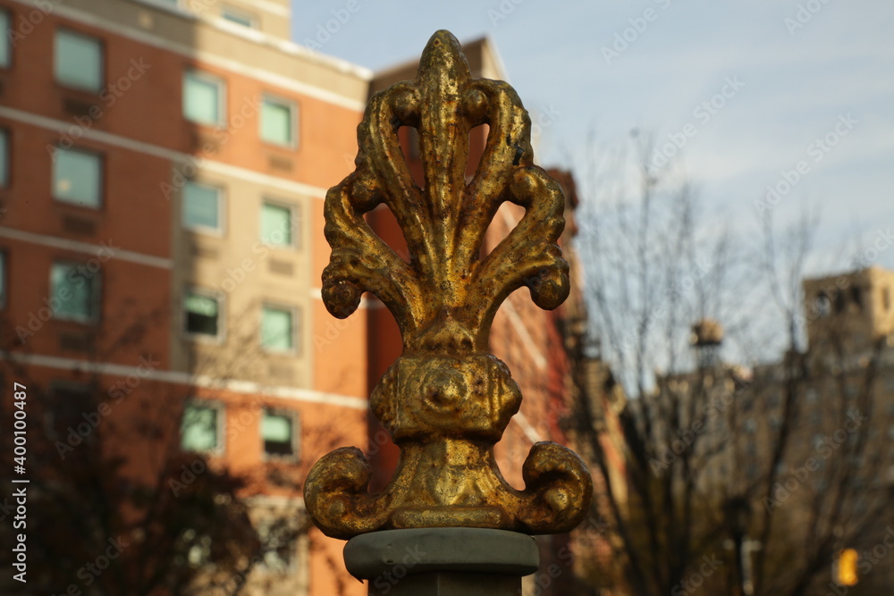 golden symbol atop a fencepost