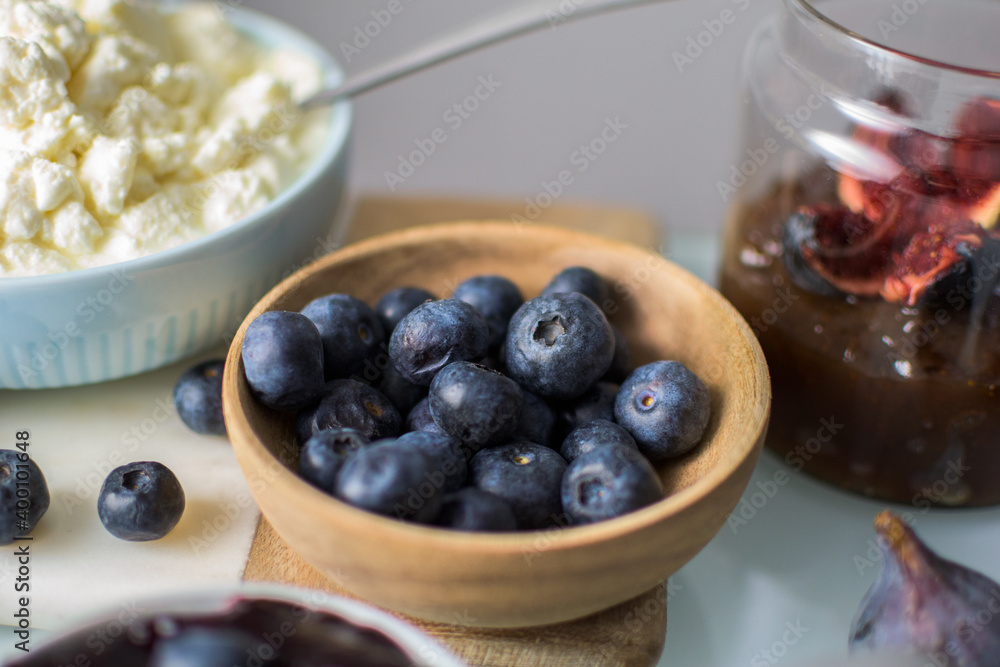 Still life of blueberries on a wooden bowl Still life of blueberries on a wooden bowl