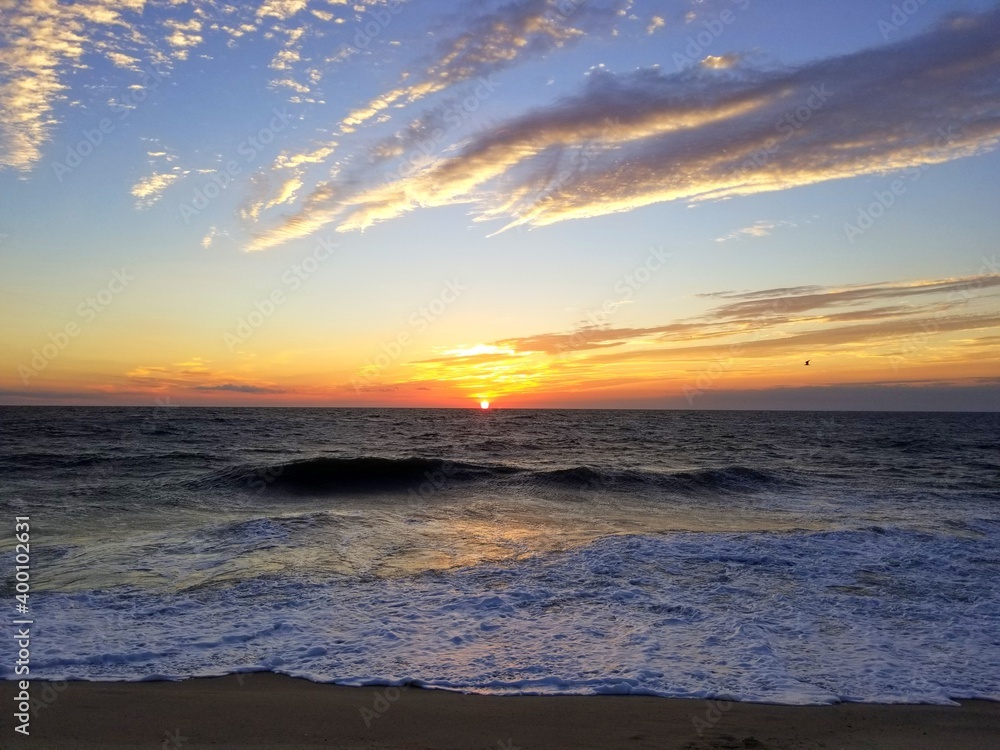 Fototapeta premium Beautiful sunrise and waves in the early morning near Dewey Beach, Delaware, U.S.A