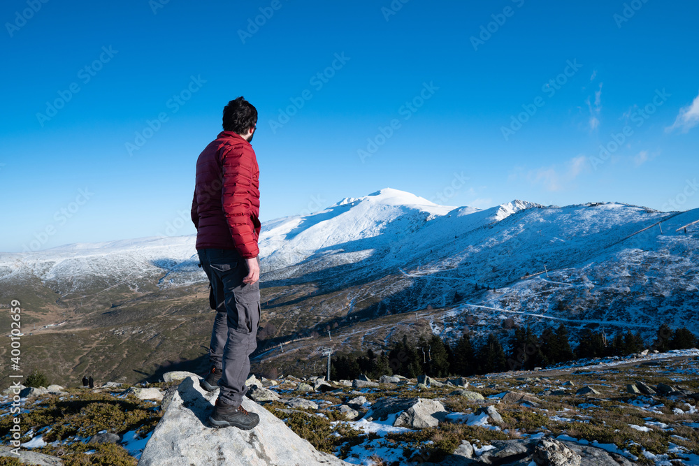 Mountaineer standing on top of snowy mountain