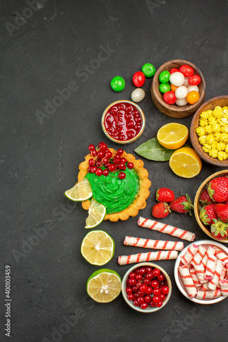 top view yummy cake with fruits and candies on a dark background cookie biscuit sweet