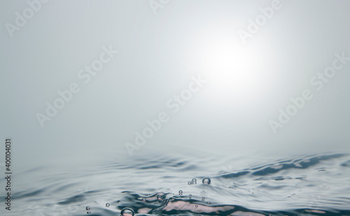 Blurred sea, there are small waves and bubbles on the water surface. The gloomy view of the sea when there is a storm.