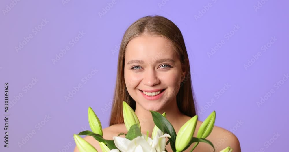 Young woman with bouquet of beautiful lilies on color background Young woman with bouquet of beautiful lilies on color background