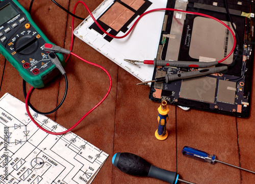 pc tablet disassembled into parts. Screwdrivers. Electronics repair shops. workplace.