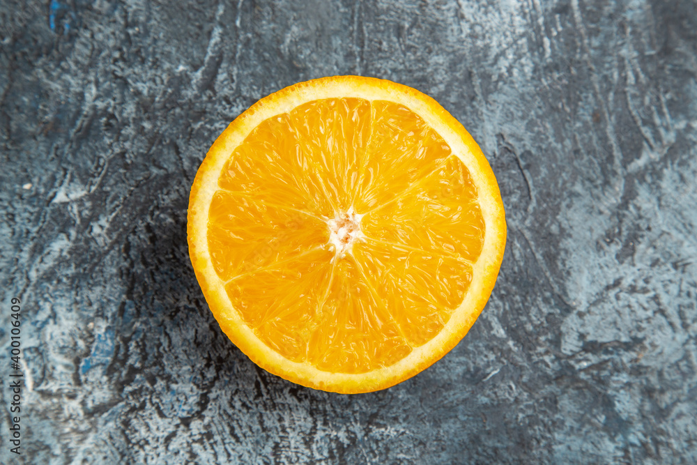 Horizontal view of cut in half fresh orange on gray background stock photo Horizontal view of cut in half fresh orange on gray background stock photo
