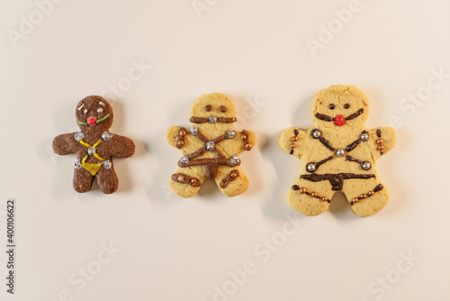 BDSM themed gingerbread cookies. fun looking cookies and a glass of milk. Sexy cookie with mouth ball and leather suit look designed in bsdm style.