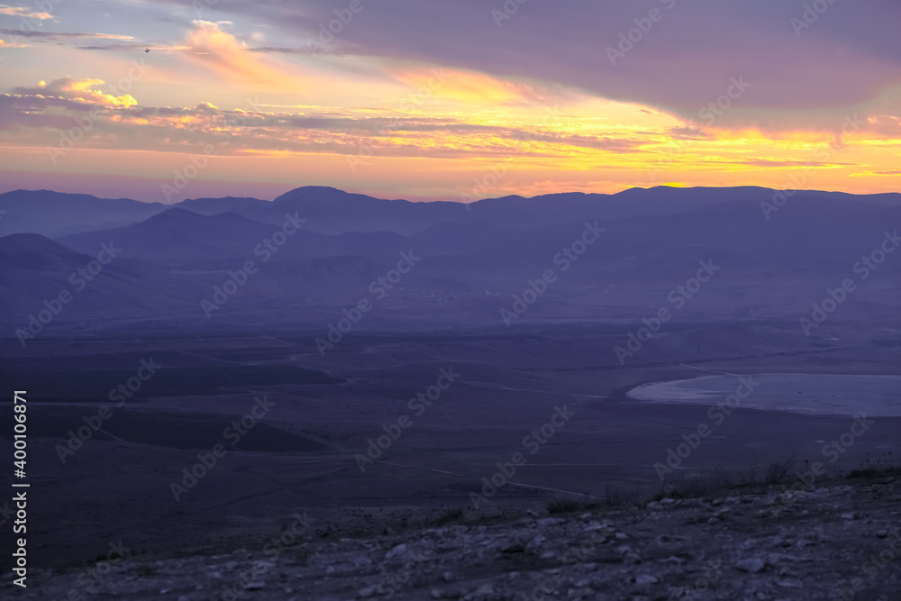 sunset with views of mountains in Crimea. Blue mountains and bright yellow sun. landscape and beautiful background