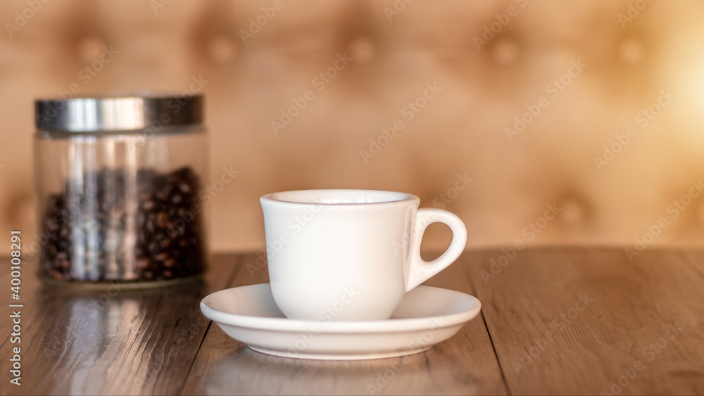 Coffee cup and saucer on a wooden table. Dark background. Coffee cup and saucer on a wooden table. Dark background.