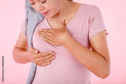 Wallpaper Mural a asian women wearing headscarf disease with hand checking lumps on her breast for signs of breast mammary cancer isolated on white blank copy space studio background,medicine concept Torontodigital.ca
