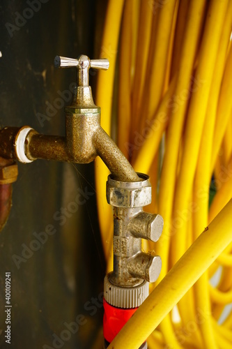 Outdoor tap with garden hose for watering in dry days.