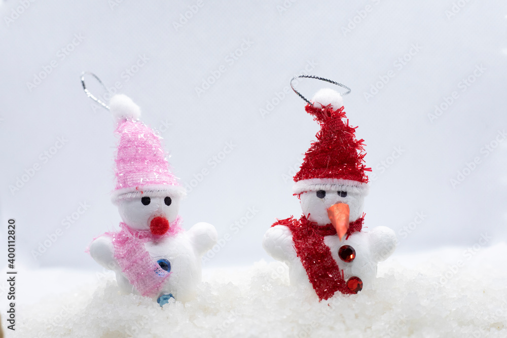 little snowmans standing in winter christmas landscape. little snowmans standing in winter christmas landscape.