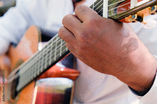 Close up image of Man playing an acoustic guitar 