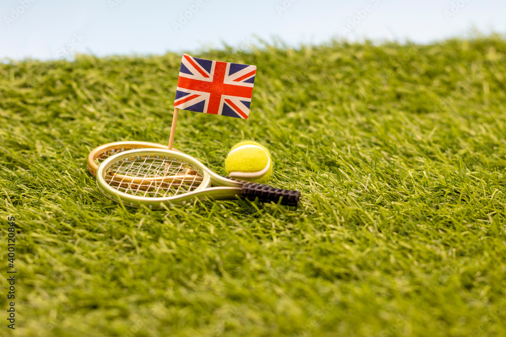 Tennis England with racket and ball with Union Jack flag on green grass  Stock Photo | Adobe Stock